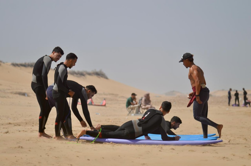 Grupo en la playa — ambiente surf camp Essaouira.